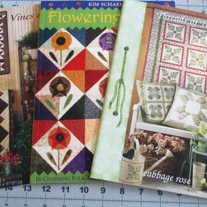 May include: Three quilting pattern books with colorful floral designs. The titles are "Vines and Flowers", "Flowering", and "Threads of Time - Cabbage Rose".