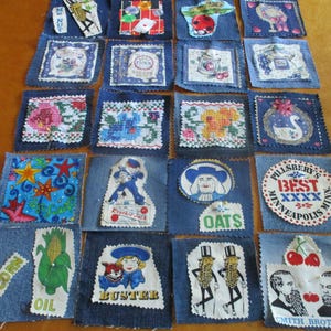 May include: A collection of twenty square denim fabric patches arranged in a grid. Each patch features a unique appliqué, including cross-stitched floral patterns, vintage food brand logos, cartoon characters, and various food illustrations.
