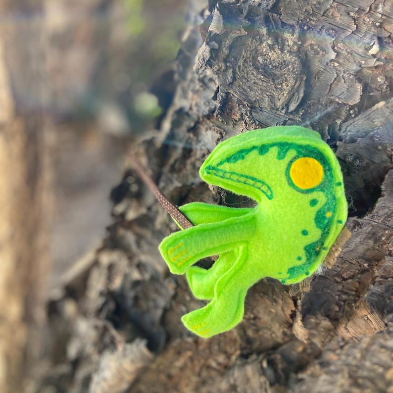 This frog is created with felt fabric in lime green and yellow. Wand is made with painted interfacing.