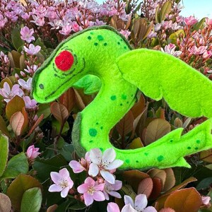 The Bear Lake Monster is made of neon and moss green felt and red eyes.