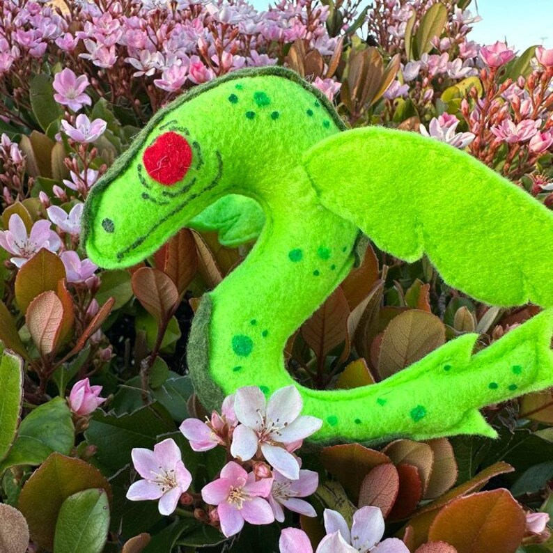 The Bear Lake Monster is made of neon and moss green felt and red eyes.