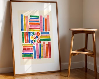 May include: A framed rectangular art print featuring a colorful illustration of stacked books in various shades of blue, green, orange, pink, and yellow. The center of the print displays the text READ MORE BOOKS in bold, multi-colored letters.