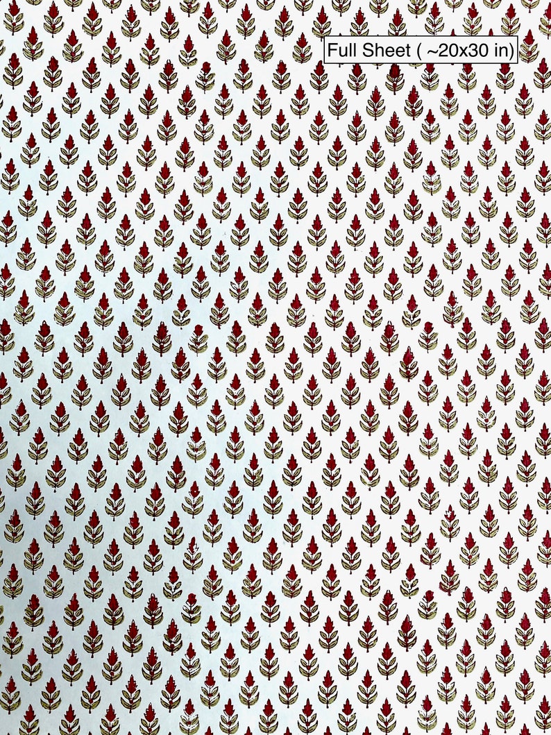 A sheet of cotton rag paper hand block printed with an Indian Buti floral design in scarlet red. The paper color is ivory and the image shows the full paper sheet scale of the print design.