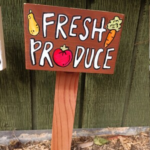 May include: A wooden sign with the words "Fresh Produce" painted in white. The sign is decorated with hand-painted images of a pear, tomato, and carrot.