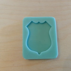 Police Badge Silicone Mold for Resin and Epoxy.  Sized for use on Badge Reels.  2" at largest dimension.  1/8" (3mm) deep.  Shiny mold