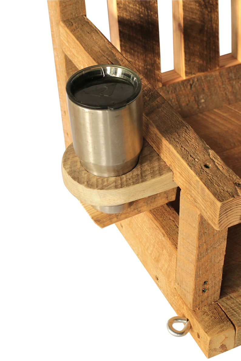 May include: A rustic wooden chair with a built-in cup holder. The cup holder is made of light-colored wood and holds a stainless steel tumbler. The chair is constructed from rough-hewn lumber, showcasing natural wood grain.