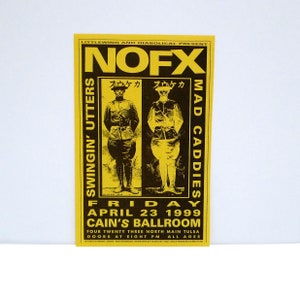 May include: A yellow and black concert poster for NOFX, Swingin' Utters, and Mad Caddies at Cain's Ballroom on April 23, 1999. The poster features two figures in military uniforms and Japanese text.