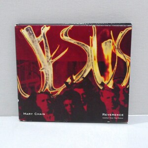 May include: A compact disc single titled "Reverence" by Mary Chain. The CD case features a dark red background with a stylized, antler-like design in yellow and white. Silhouetted faces are visible at the bottom.
