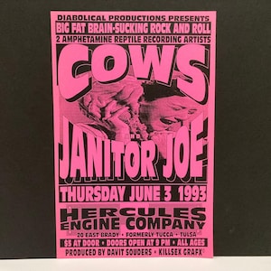 May include: A bright pink rectangular concert poster with black text and graphics. It features the bands Cows and Janitor Joe, the date Thursday June 3 1993, and the venue Hercules Engine Company in Tulsa. The design includes a central black and white image of a person with their hands near their face.