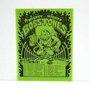 May include: A neon green concert poster for The Mighty Mighty Bosstones' Midwest Fall Tour '96. The poster features a cartoon devil holding a microphone. Tour dates and venues are listed in black text.