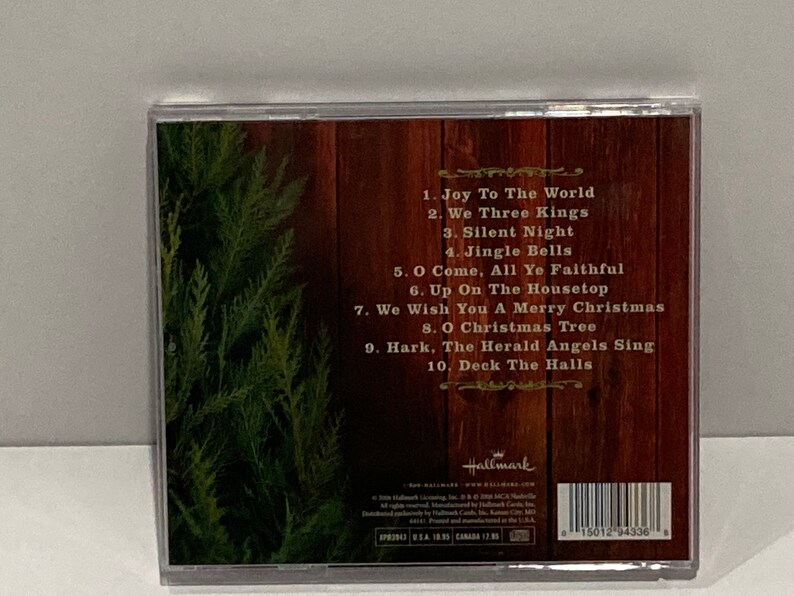 May include: A George Straight Christmas CD with green pine tree on the left side. The back of the case lists the following songs: Joy To The World, We Three Kings, Silent Night, Jingle Bells, O Come, All Ye Faithful, Up On The Housetop, We Wish You A Merry Christmas, O Christmas Tree, Hark, The Herald Angels Sing, Deck The Halls.