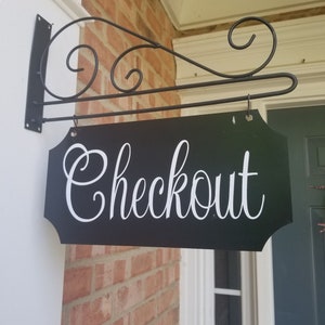 This is a custom metal hanging sign with a hanging rod and hanging hardware which are included. The sign is black with white writing. The writing is able to be perosnalized by you choosing your font and font color.