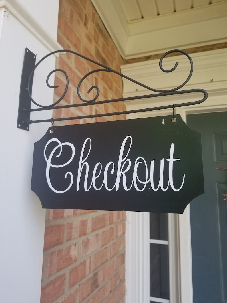 This is a custom metal hanging sign with a hanging rod and hanging hardware which are included. The sign is black with white writing. The writing is able to be perosnalized by you choosing your font and font color.