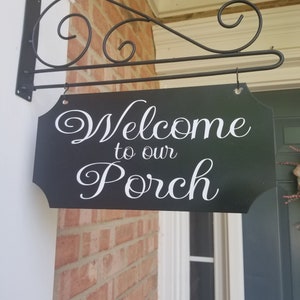 This is a custom metal hanging sign with a hanging rod and hanging hardware which are included. The sign is black with white writing. The writing is able to be perosnalized by you choosing your font and font color.