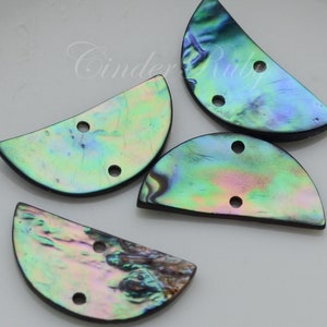 May include: Four iridescent abalone shell half-circle buttons with two holes each. The buttons are a mix of green, blue, and purple.
