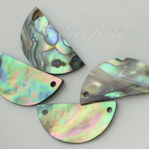 May include: Four iridescent abalone shell half-circle shapes with two holes each. The shells have a green, blue, and purple iridescent sheen.