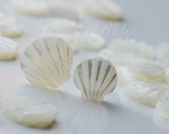May include: A collection of white mother of pearl shell buttons in various sizes and shapes. The buttons are smooth and have a subtle iridescent sheen.