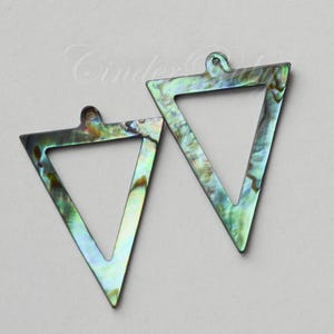 May include: Two iridescent green and blue triangle shaped shell pendants with a hole at the top for hanging.