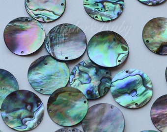 May include: A collection of iridescent round abalone shell sequins with two holes each. The sequins are various shades of green, blue, and purple.