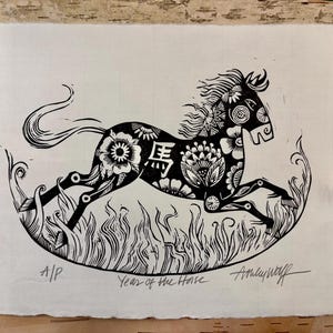 May include: Black and white linocut print of a horse in motion, decorated with floral patterns. The Chinese character for "horse" is visible. The print is titled "Year of the Horse" and signed by the artist.