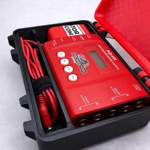 May include: A custom black travel case with a red interior, holding a red MD-HX cross converter and accessories. The case is open, revealing the converter with white buttons and the text "Decimator". The text "Custom MD-HX Travel Case" is at the top.