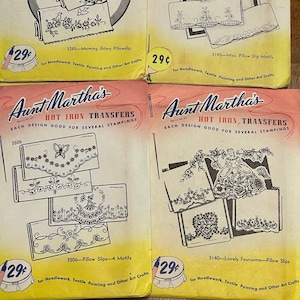 May include: Four vintage iron-on transfer designs for needlework, textile painting, and other crafts. Each design features a different motif, including a floral pattern, a butterfly, a heart, and a pillow slip. The transfers are labeled "Aunt Martha's Hot Iron Transfers" and are priced at 29 cents each.