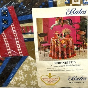 May include: A round tablecloth in a patchwork design with blue, red, brown, and white floral and geometric patterns. The packaging features the Bates brand name, the text The Match Makers, Serendipity, and care instructions for this 72 inch round item.