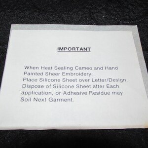 May include: A white sheet of paper with the word "IMPORTANT" printed in black at the top. The text below explains how to use a silicone sheet when heat sealing cameo and hand painted sheer embroidery.