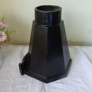May include: Black cast iron hexagonal base with a round top opening. The base has a decorative side piece.