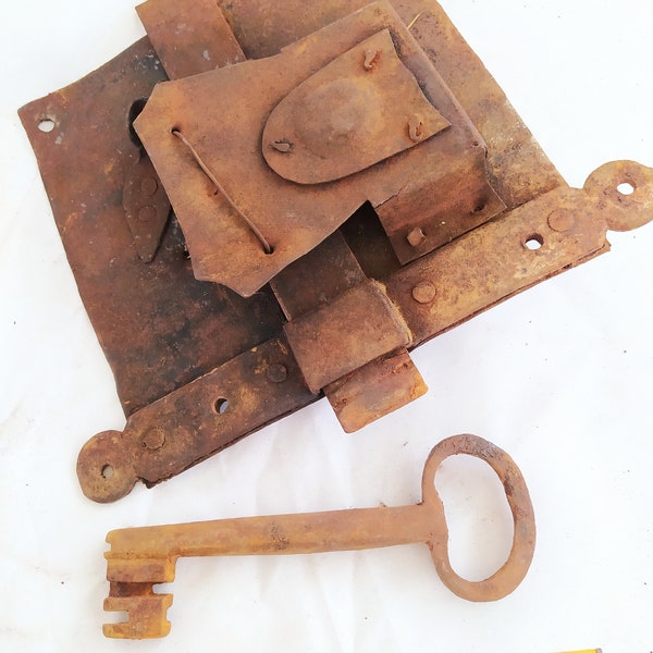 Antique hand forged iron door lock with key.