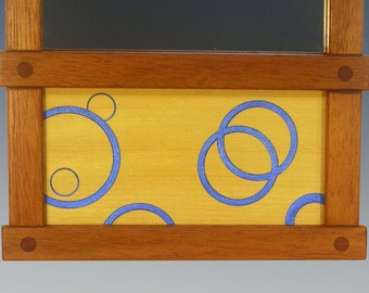 mahogany mirror with yellowheart carved circle panel