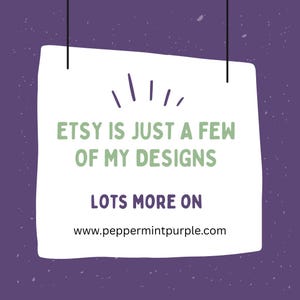 May include: A white paper sign with the text "ETSY IS JUST A FEW OF MY DESIGNS" in green letters. Below, the text "LOTS MORE ON" is written, followed by a website address. The background is a speckled purple.