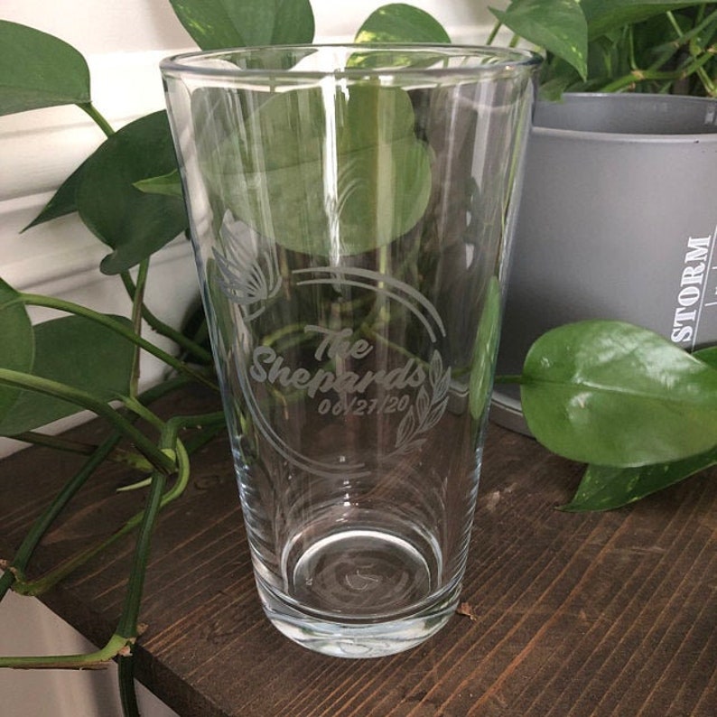 May include: A clear glass pint glass with an etched design that says "The Shepards 06/21/20".