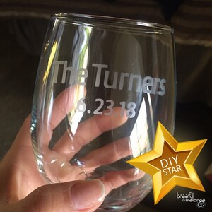 May include: A clear glass wine glass with the text "The Turners 6.23.18" etched into the side.