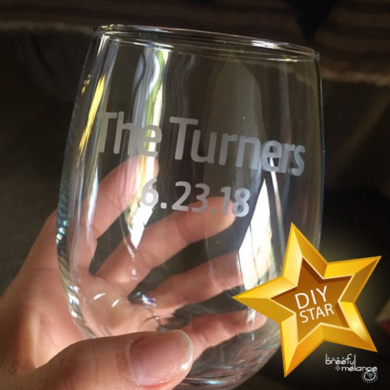 May include: A clear glass wine glass with the text "The Turners 6.23.18" etched into the side.