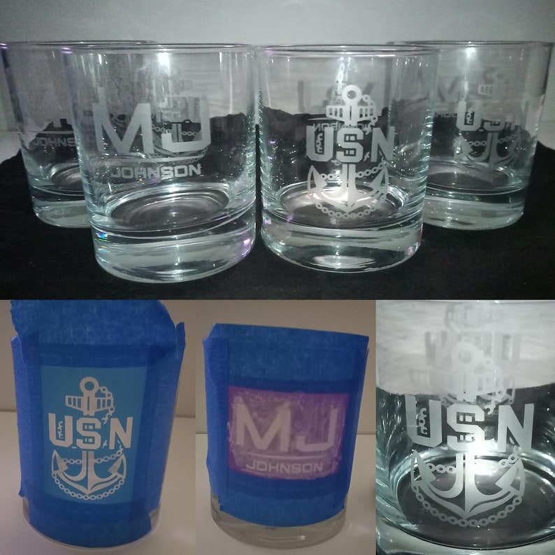 May include: Three clear glass tumblers with etched designs. One tumbler has the initials "MJ" and the name "JOHNSON" etched on it. The other two tumblers have the acronym "USN" and an anchor etched on them.
