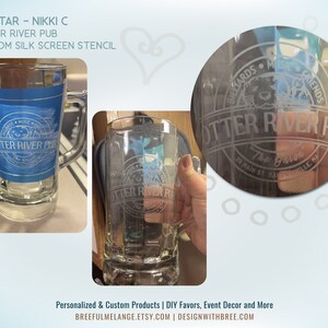 May include: A clear glass beer stein with a custom etched design. The design features the text "Otter River Pub" and a logo with a cartoon otter. The stein is shown next to a blue and white version of the same design.
