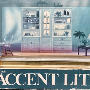 May include: A 30-inch accent light with a clear glass tube and a gold trim. The light is shown in a room with furniture and plants.