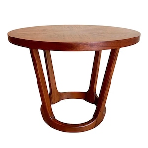 May include: A round wooden side table with a unique, open base design. The table has a dark brown wood finish and a smooth, circular top.