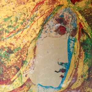 May include: Abstract painting of a woman's face with yellow, red, blue, and green colors. The woman's face is in profile and her hair is flowing.
