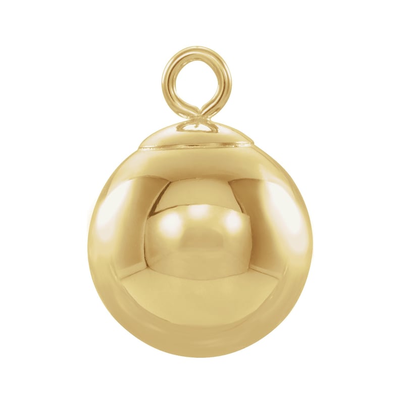 May include: A gold-colored metal ball charm with a loop at the top. The ball is smooth and shiny.