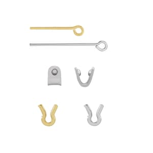 May include: An assortment of jewelry findings, including gold and silver eye pins, and U-shaped clasps. The eye pins have a loop at one end. The clasps are in gold and silver tones, with a curved design.