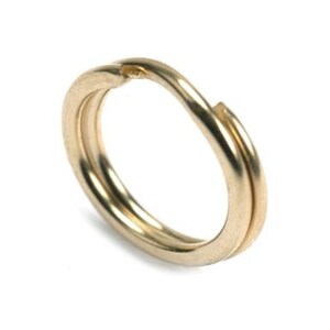 May include: A gold-colored metal key ring with a double loop design.