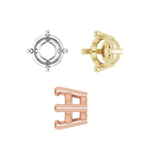 May include: Three different metal jewelry settings are displayed against a white background. The settings are in silver, gold, and rose gold. The silver setting is circular with four small spheres. The gold setting is a circular cage. The rose gold setting is a three-prong design.