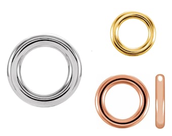May include: Three jump rings in different metal finishes: silver, gold, and rose gold. The rings are all the same size and shape.