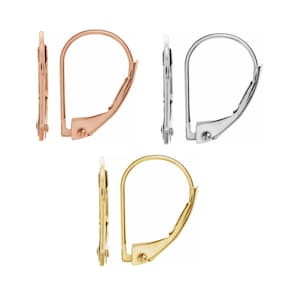 May include: Three pairs of earring backs in gold, rose gold, and silver. Each pair is a lever back style.