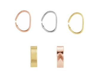 May include: Set of five gold, silver, and rose gold jump rings. The jump rings are oval shaped and have a smooth finish. Two of the jump rings are open and three are closed.
