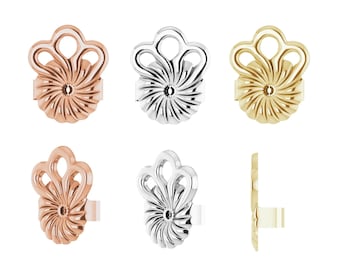 May include: Set of six earring backs in three different metal finishes: rose gold, silver, and gold. Each back features a decorative design with a swirl pattern and three loops.