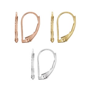 May include: Three pairs of earring backs in gold, rose gold, and silver. Each pair is made of metal and has a lever back closure.