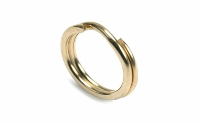 May include: A gold-colored metal key ring with a double loop design.
